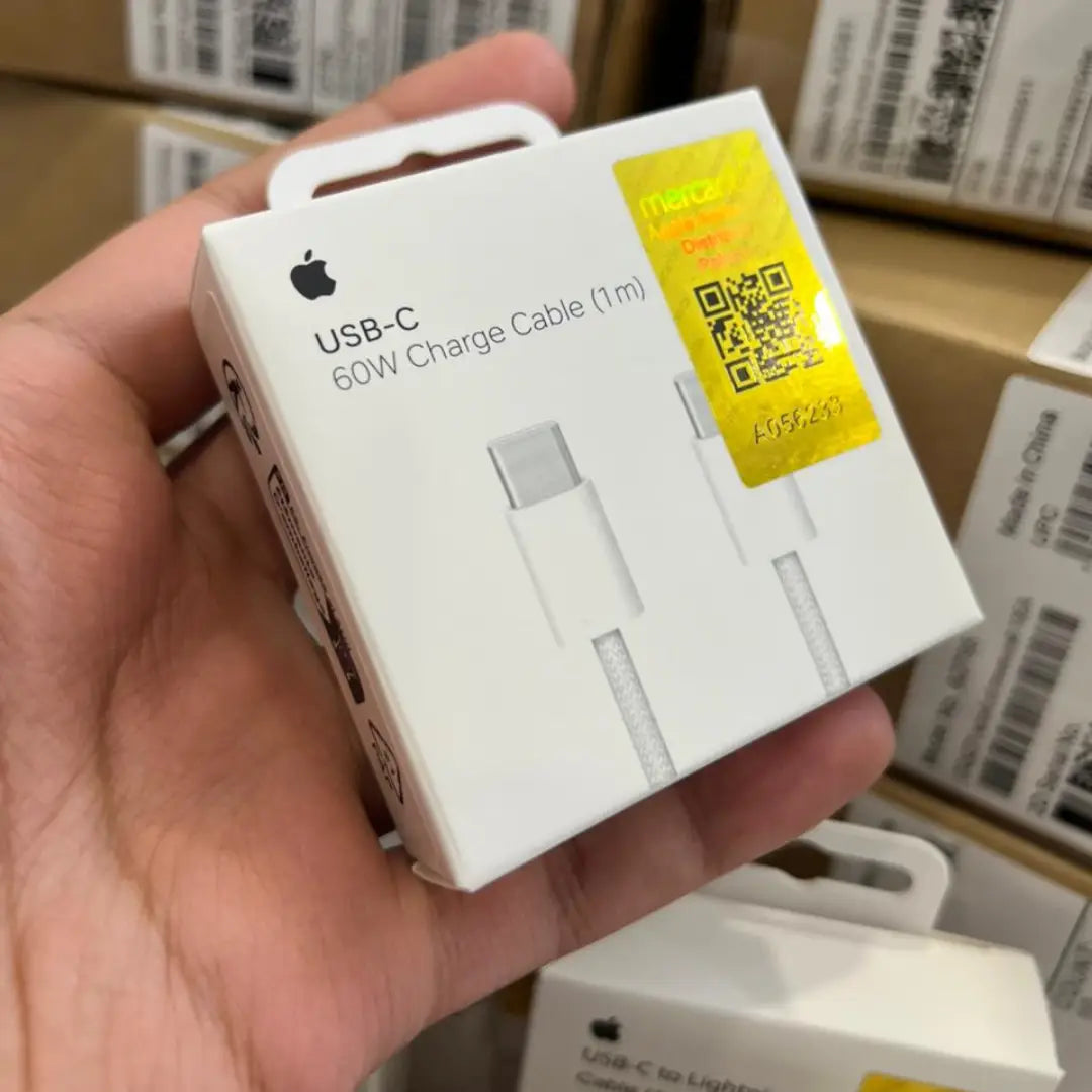 Hand holding an Apple USB-C charge cable packaging with a QR code label.