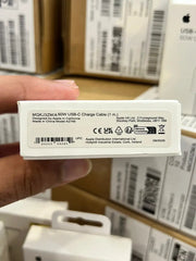 Apple USB-C charge cable packaging held by a hand